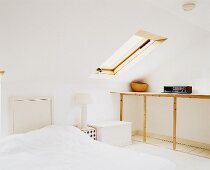 A loft bedroom with a skylight