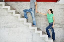 A man leading his girlfriend upstairs