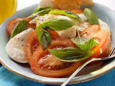 Tomatoes with mozzarella and basil; white bread