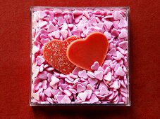 Red chocolate hearts and pink sugar hearts in box