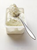 Quark in plastic container with spoon