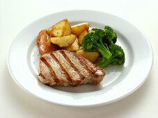 Pork steak with broccoli and fried potatoes