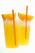 Orange juice with crushed ice, orange wedges and straw