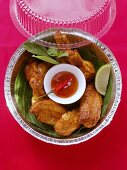 Crispy chicken wings with chili dip in lunch box