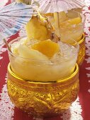 Thai sangria with pineapple in golden bowl