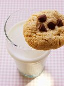 Chocolate chip cookie on a glass of milk