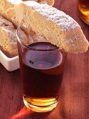 Italian almond biscuits (cantucci) on glass of Vin Santo