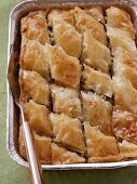 Baklava in aluminium dish with cake slice