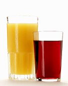 Orange juice and red grape juice in glasses