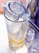 Bar strainer on glass with drink