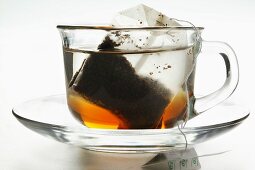 Freshly made tea in glass cup with tea bag