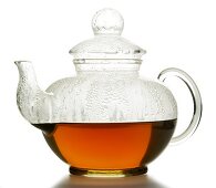Hot fruit tea in glass teapot