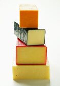 Various types of cheese, in a pile