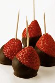 Chocolate-coated strawberries on toothpicks