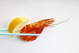 Shrimp with lemon on chopsticks