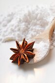 Star anise and icing sugar on kitchen spoon