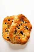 Two focaccia with olives and rosemary