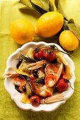 Ravioli with scampi, tomatoes and olives; lemons