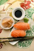 Nigiri-sushi with salmon; ginger; soy sauce; wasabi
