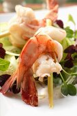 Salad with shrimps skewered on lemon grass