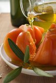 Pouring olive oil over tomatoes