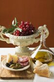 Olives, sausage, Parmesan, bread, olive oil and red grapes