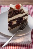 Piece of Black Forest gateau with cherry