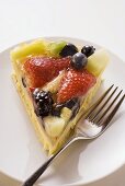 Piece of fruit gateau with fork