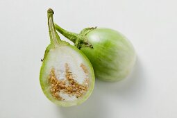 Green baby aubergine, halved