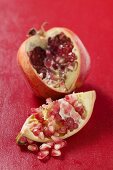 Pomegranate, cut open, on red background