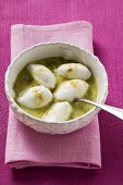 Poached meringues with pistachio sauce