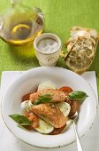 Tomatoes with mozzarella, salmon and basil