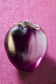 An aubergine on purple background