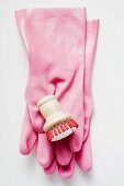 Pink rubber gloves and brush