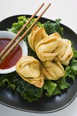 Deep-fried wontons with sweet and sour sauce