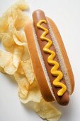 Hot dog with mustard and potato crisps