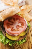 Home-made hamburger with gherkins, onions, tomato