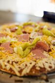 Pizza with ham, mushrooms, peppers and cheese