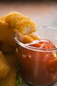 Fish finger with ketchup (a bite taken)