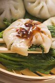 Yeast dumplings with chive filling on pak choi (Thailand)