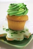 Muffin with green cream & shamrock biscuit for St. Patricks Day