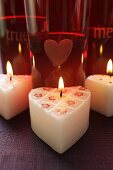 Burning heart-shaped candles for Valentine's Day