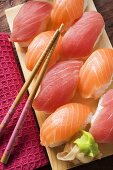 Nigiri sushi with tuna and salmon on sushi board
