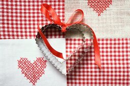 Heart-shaped biscuits with red gift ribbon