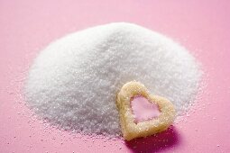Heart-shaped biscuit on granulated sugar