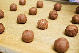 Small balls of hazelnut dough on a baking tray