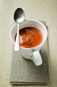 Red pepper cream soup in soup cup