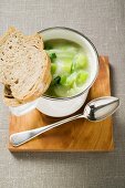 Creamed leek soup with bread and spoon