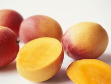 Fresh mangos, one halved