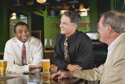 Three men at the bar in a pub